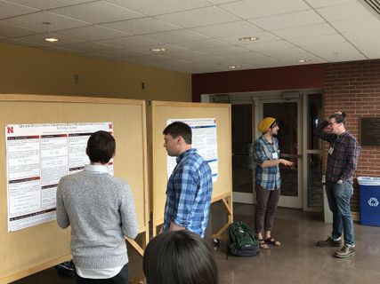 View of hallway showing multiple algebra posters and attendees 